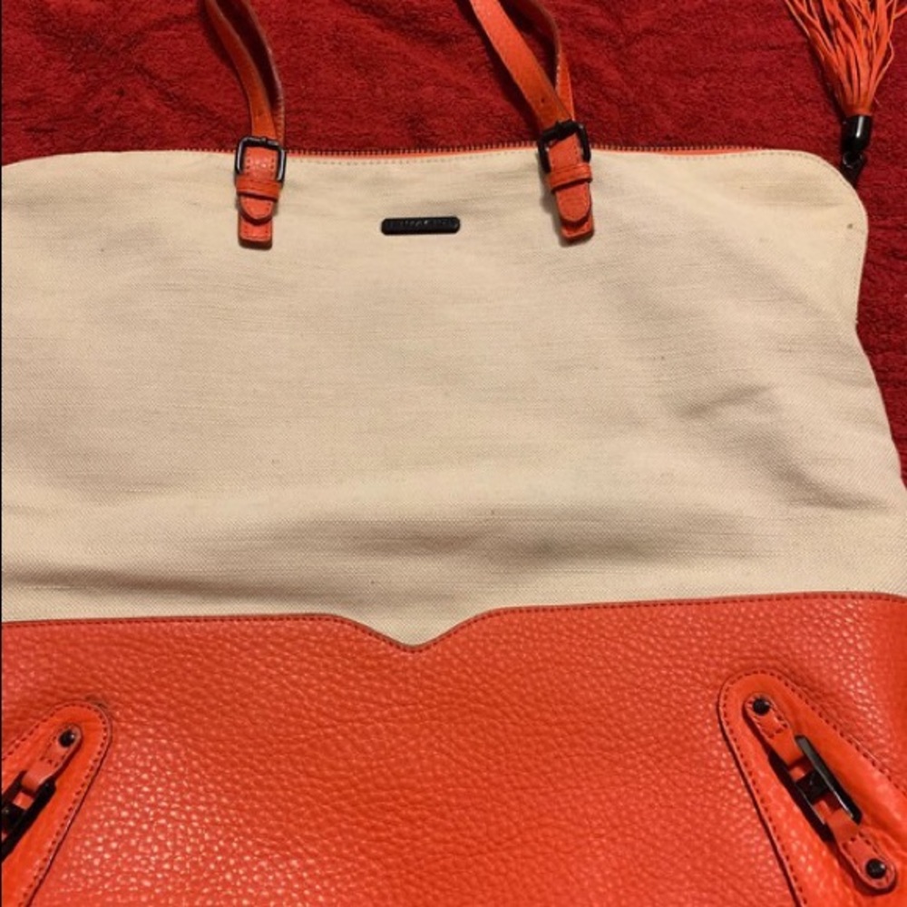 A Rebeccaminkoff tangerine,beige handbag once worn